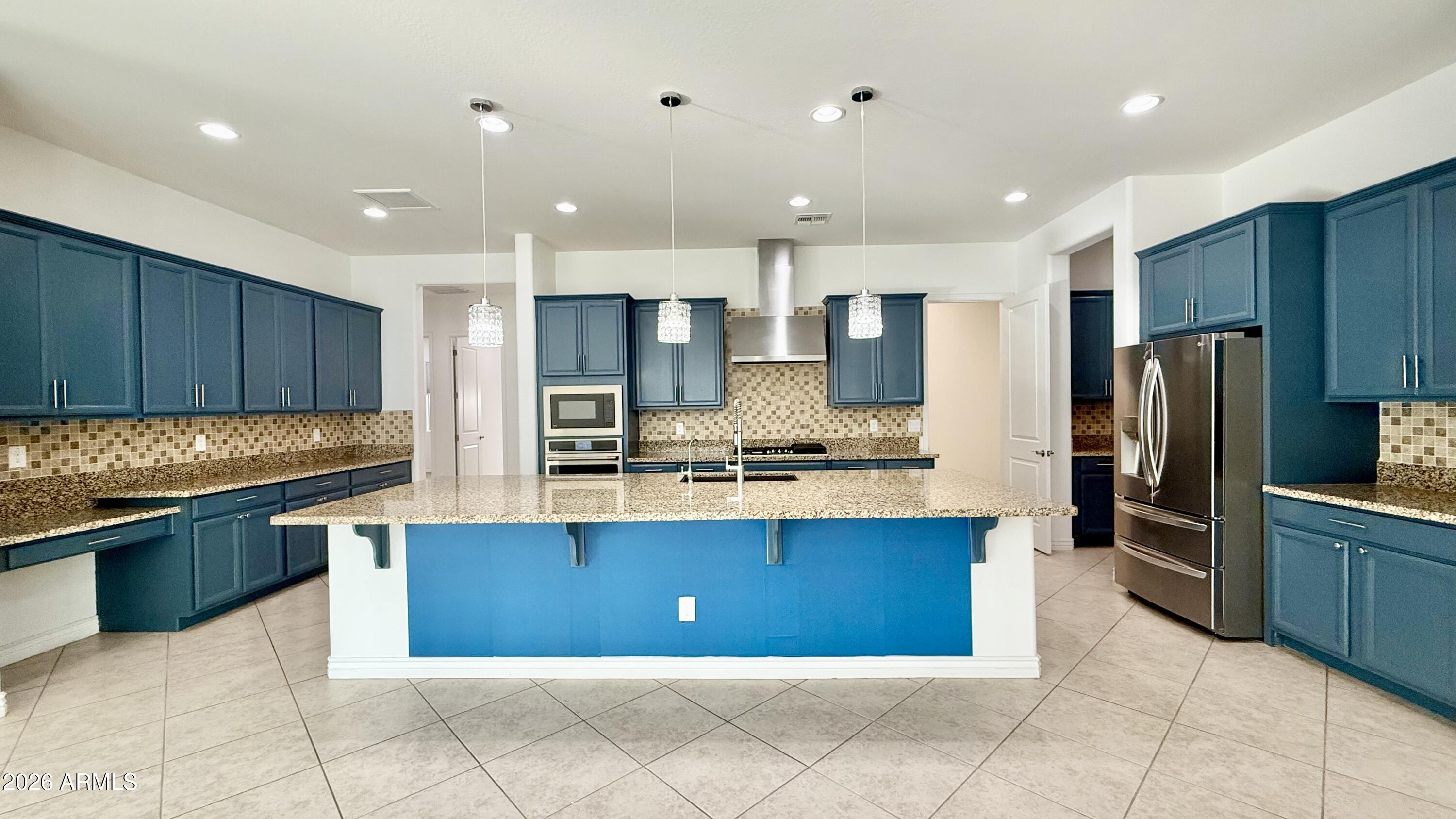 3355 East Constance Way Phoenix, AZ 85042 - Photo 6 of 42 a large kitchen with granite countertop a large counter top stainless steel appliances and cabinets