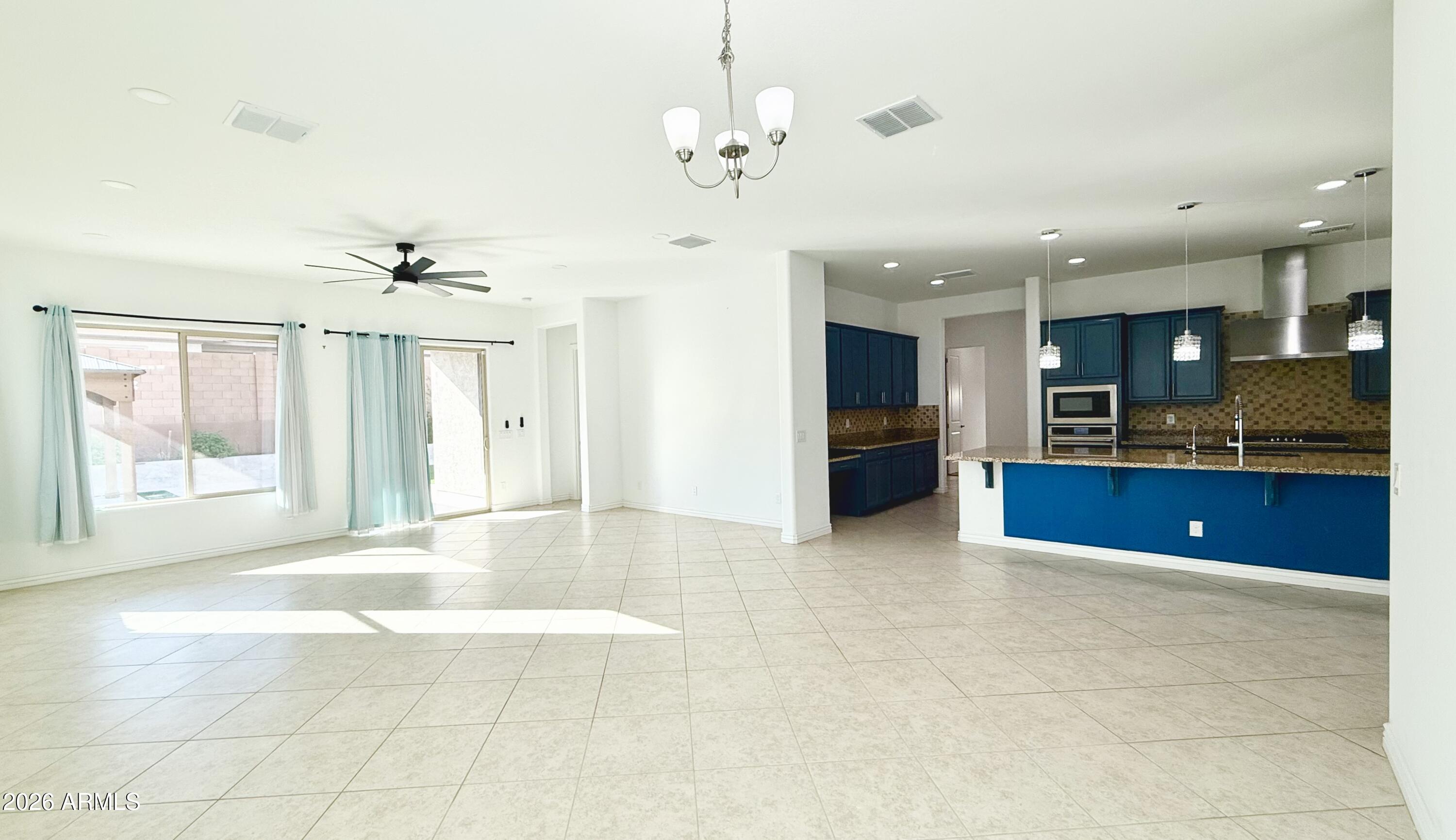 3355 East Constance Way Phoenix, AZ 85042 - Photo 8 of 42 a view of an empty room with kitchen and window