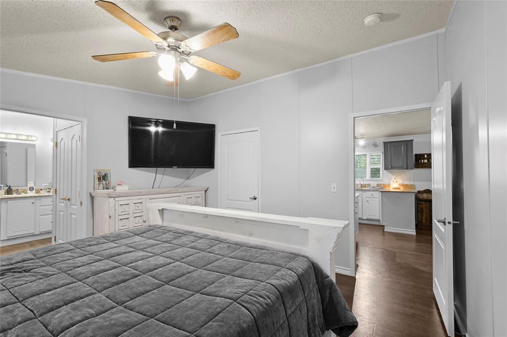 338 Fisherman Road Pottsboro, TX 75076 - Photo 20 of 24 Wood-finish flooring, ceiling fan with light fixture, and white interior doors