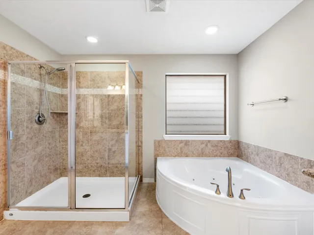 a spacious bathroom with a granite countertop tub sink and mirror