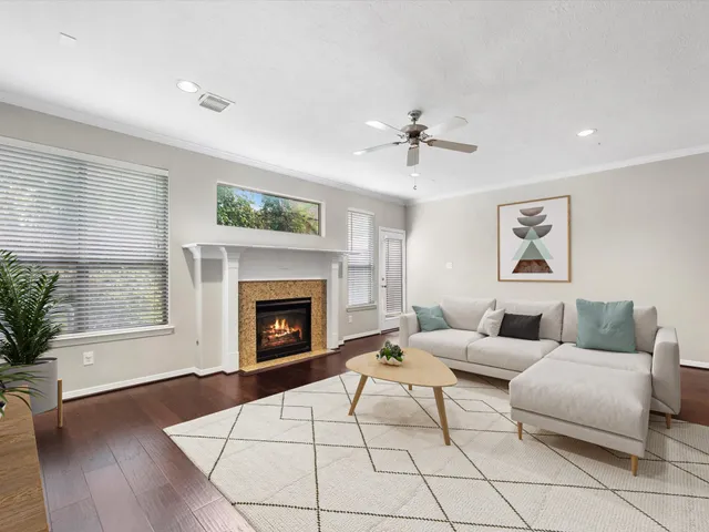 a living room with furniture a window and a fireplace