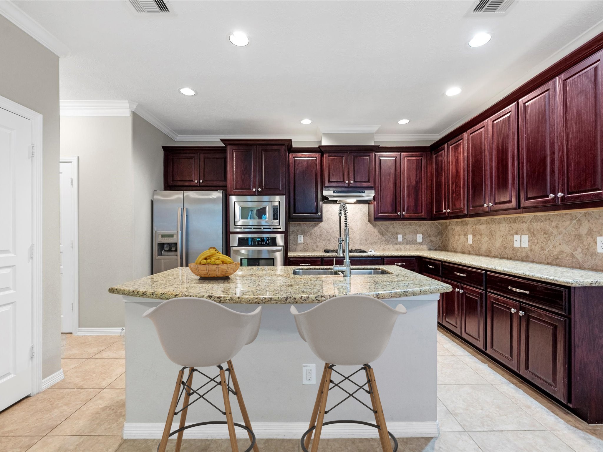1506 Nashua Street Houston, TX 77008 - Photo 6 of 26 Two counter height seats comfortably fit at the kitchen island. Pantry is through the double doors to the left.
(Virtually staged)