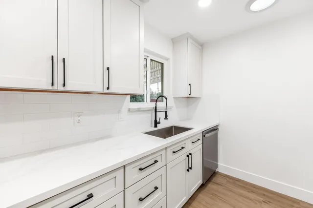 a kitchen with stainless steel appliances a sink stove and refrigerator
