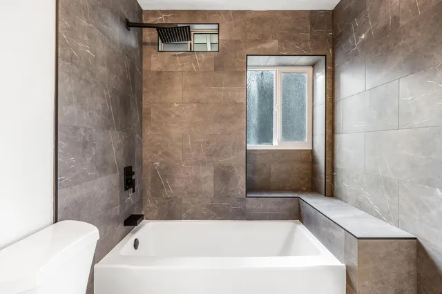 a spacious bedroom with a bed and a couch