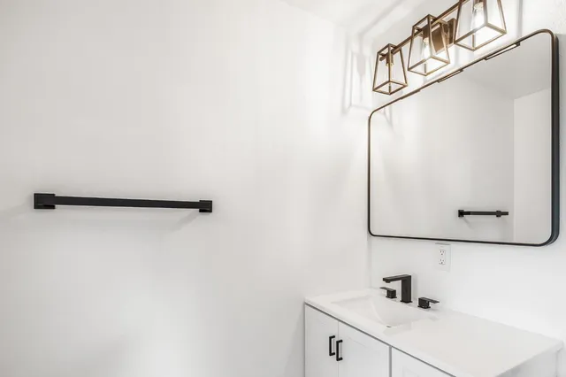 an empty room with wooden floor and a window