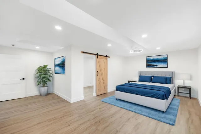 a view of a room with wooden floor and white walls