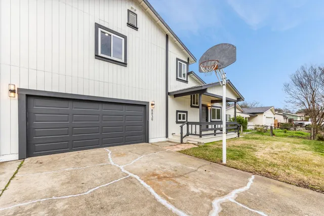 a front view of a house with large windows