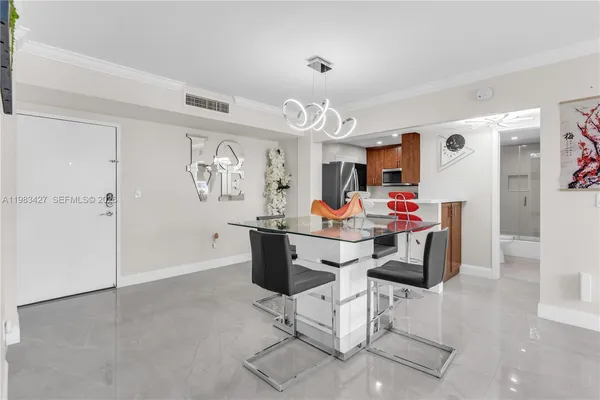 a view of a dining room with furniture and a chandelier