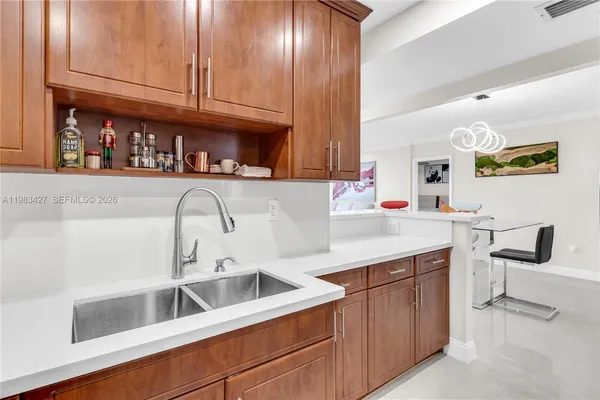 a kitchen with stainless steel appliances granite countertop a sink and cabinets