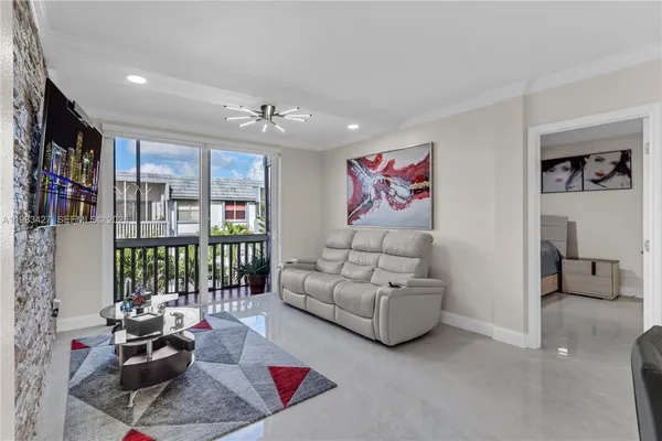 a living room with furniture and a floor to ceiling window