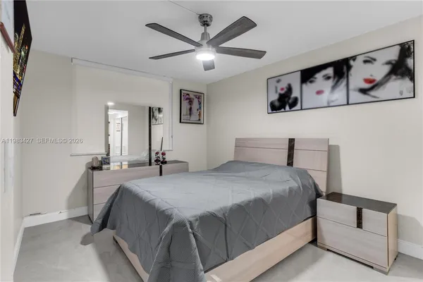 a spacious bedroom with a bed and dresser