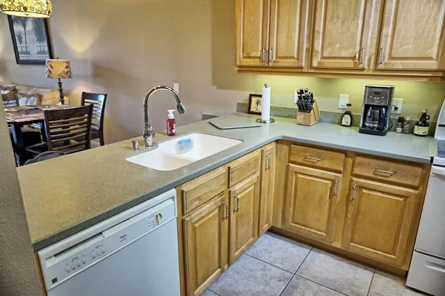 a kitchen with stainless steel appliances granite countertop a sink dishwasher stove and cabinets