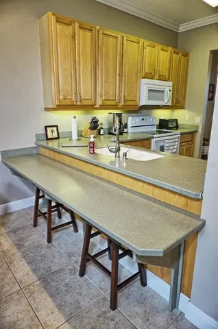a view of kitchen with table and chairs