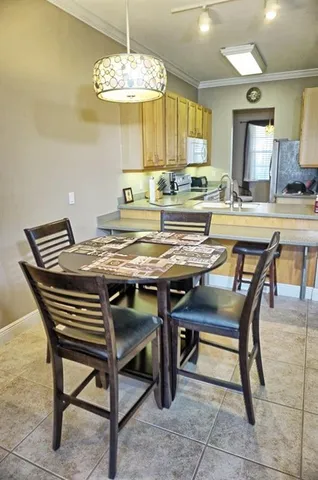 a view of a dining room with furniture and a chandelier