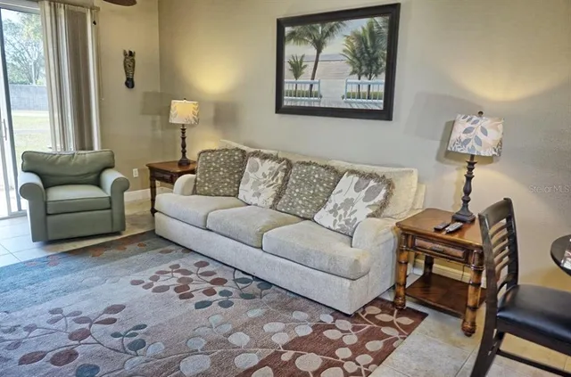 a living room with furniture and a lamp