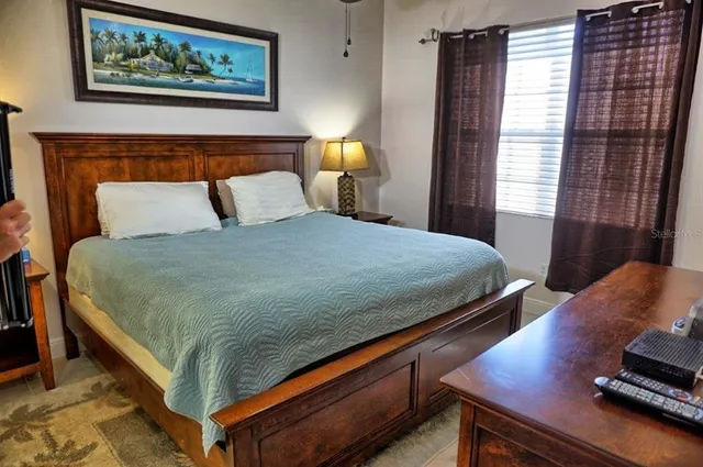 a bedroom with a bed and chandelier