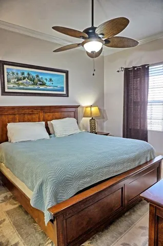 a bedroom with a bed a lamp on dresser and a lamp