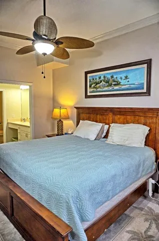 a bedroom with a bed and a flat tv screen on dresser