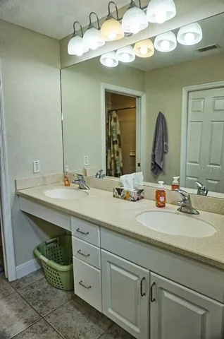 a bathroom with a double vanity sink and a mirror