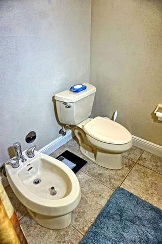 a bedroom with a bed and chair