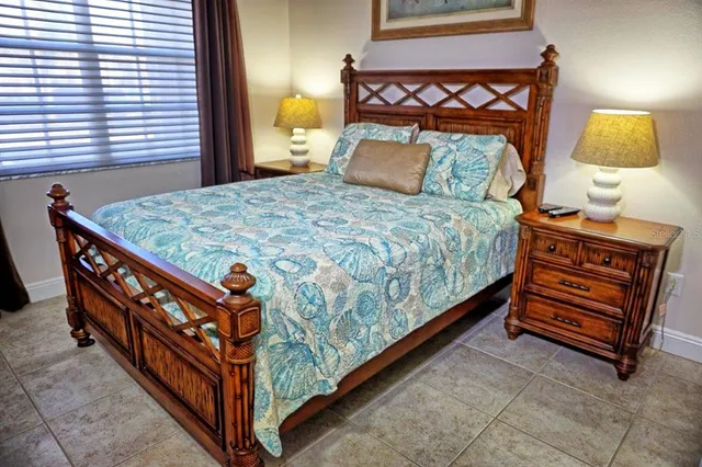 a bedroom with bed and window