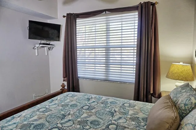 a bathroom with a toilet sink vanity and shower