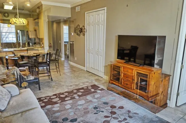 a view of living room filled with furniture and flat screen tv