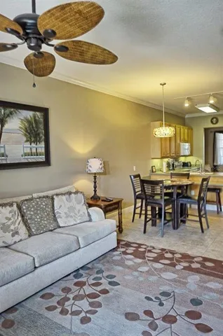 a living room with furniture and kitchen view