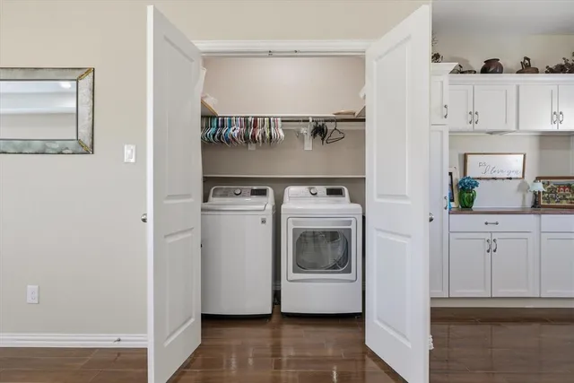a utility room with cabinets dryer and washer