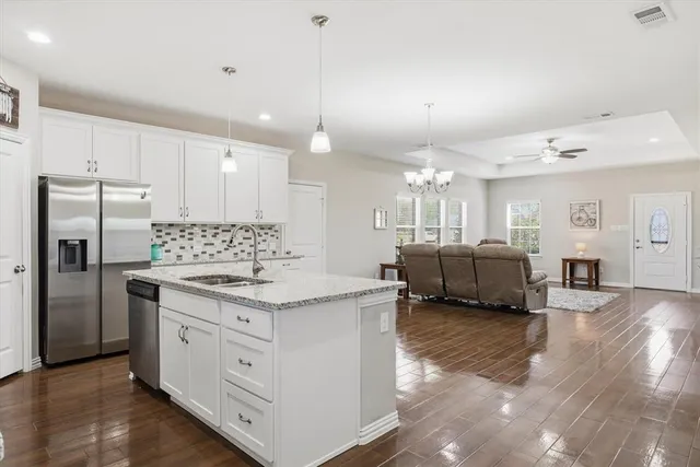 a kitchen with a sink cabinets and refrigerator
