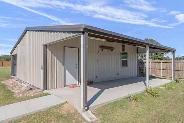 a view of backyard with small cabin