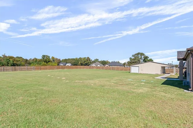 a view of a lake with houses in the back