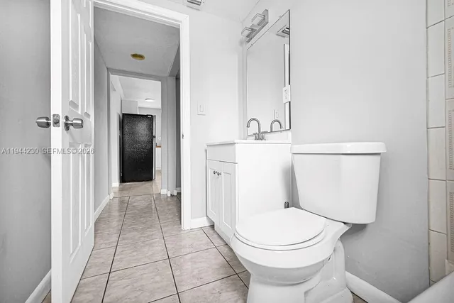 a view of a hallway with closet and a bathroom