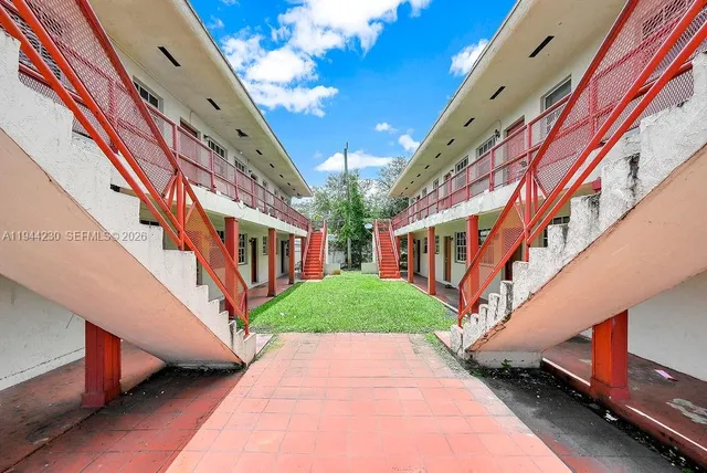 a view of a building with a yard