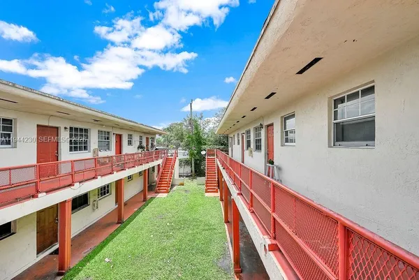 a house view with swimming pool and deck