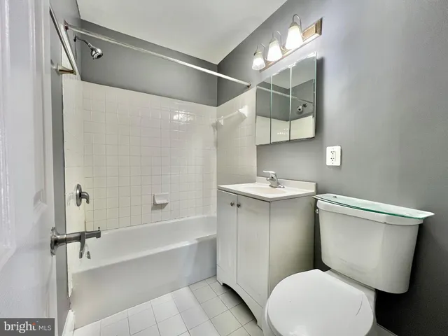 a bathroom with a toilet a sink and bathtub