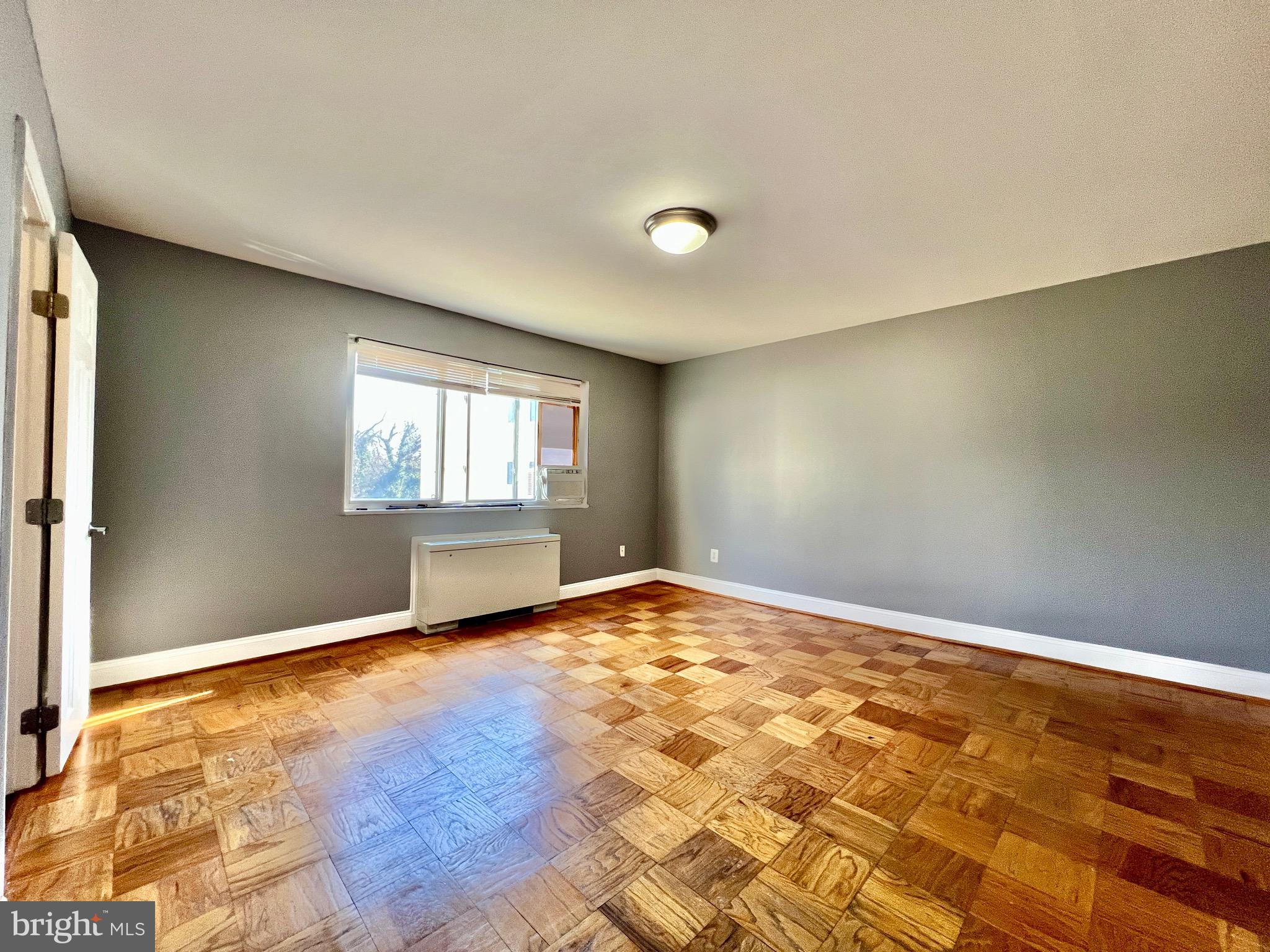 1009 Chillum Road, Unit 202 Hyattsville, MD 20782 - Photo 12 of 19 an empty room with wooden floor and windows