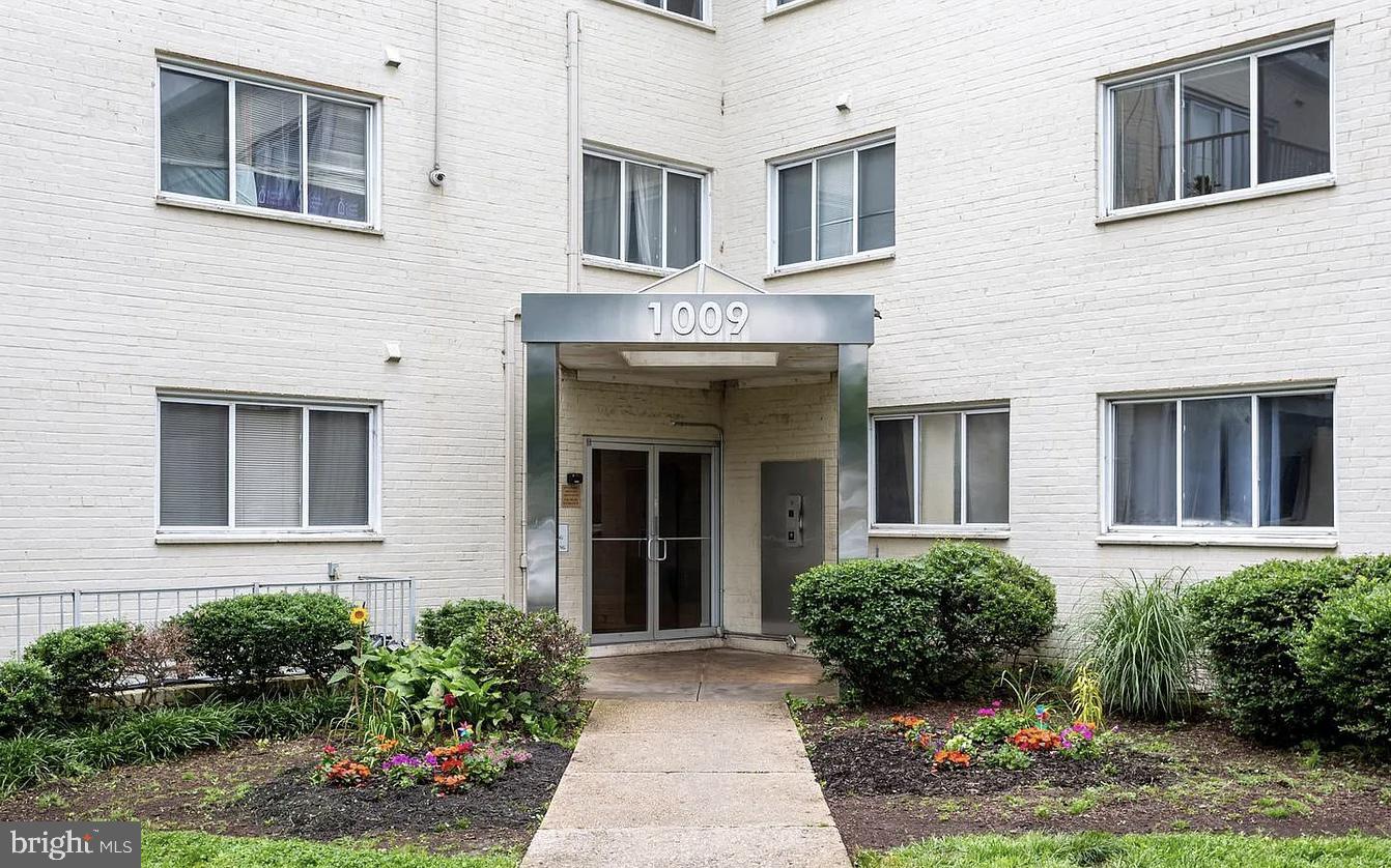 1009 Chillum Road, Unit 202 Hyattsville, MD 20782 - Photo 18 of 19 a view of a brick house with lots of windows and flower plants