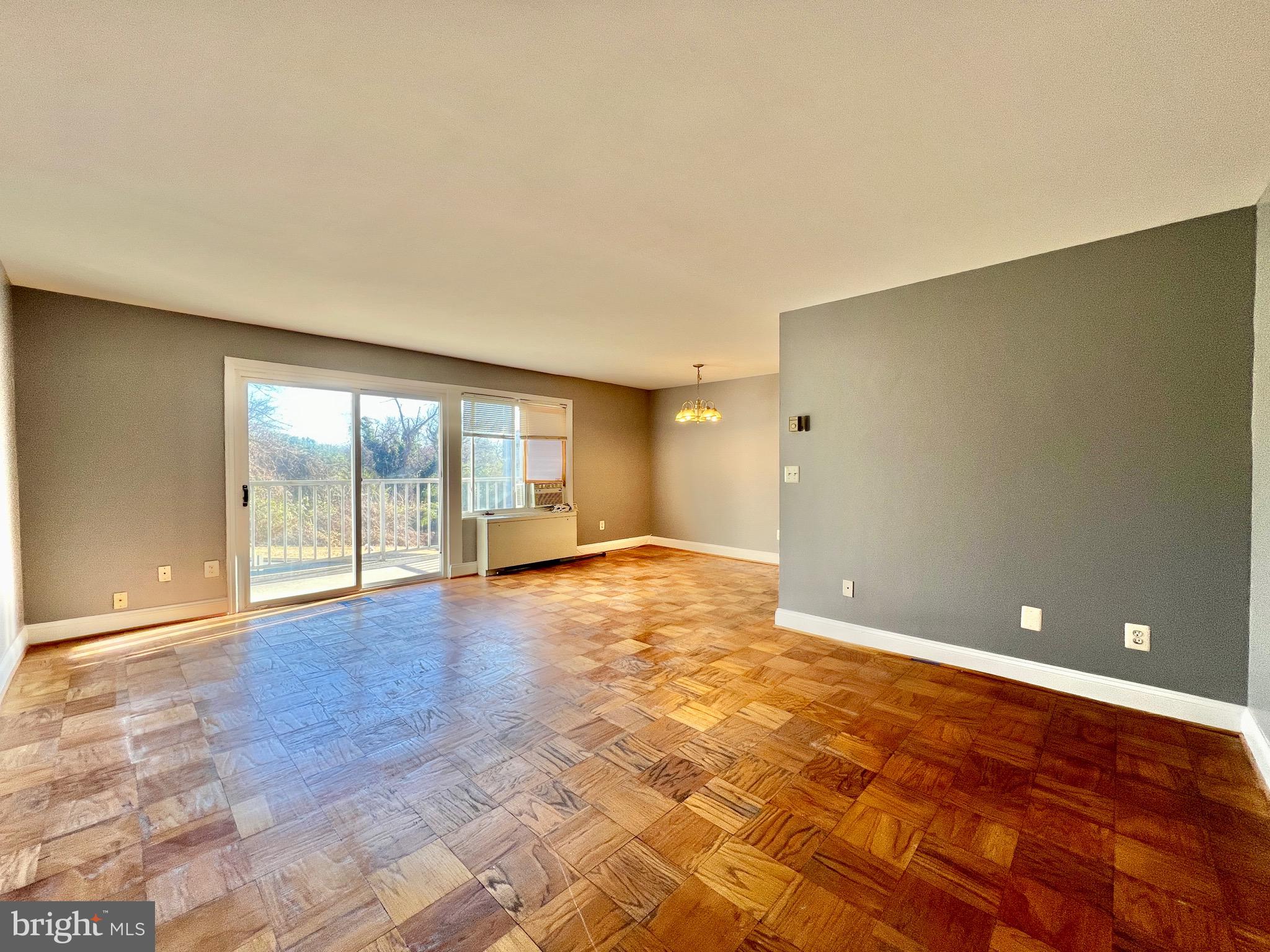 1009 Chillum Road, Unit 202 Hyattsville, MD 20782 - Photo 2 of 19 a view of an empty room with wooden floor and a window