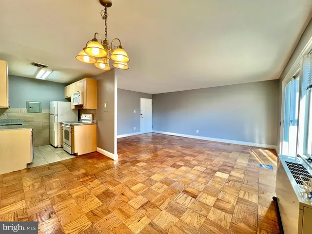 a view of a kitchen with a sink stainless steel appliances and cabinets