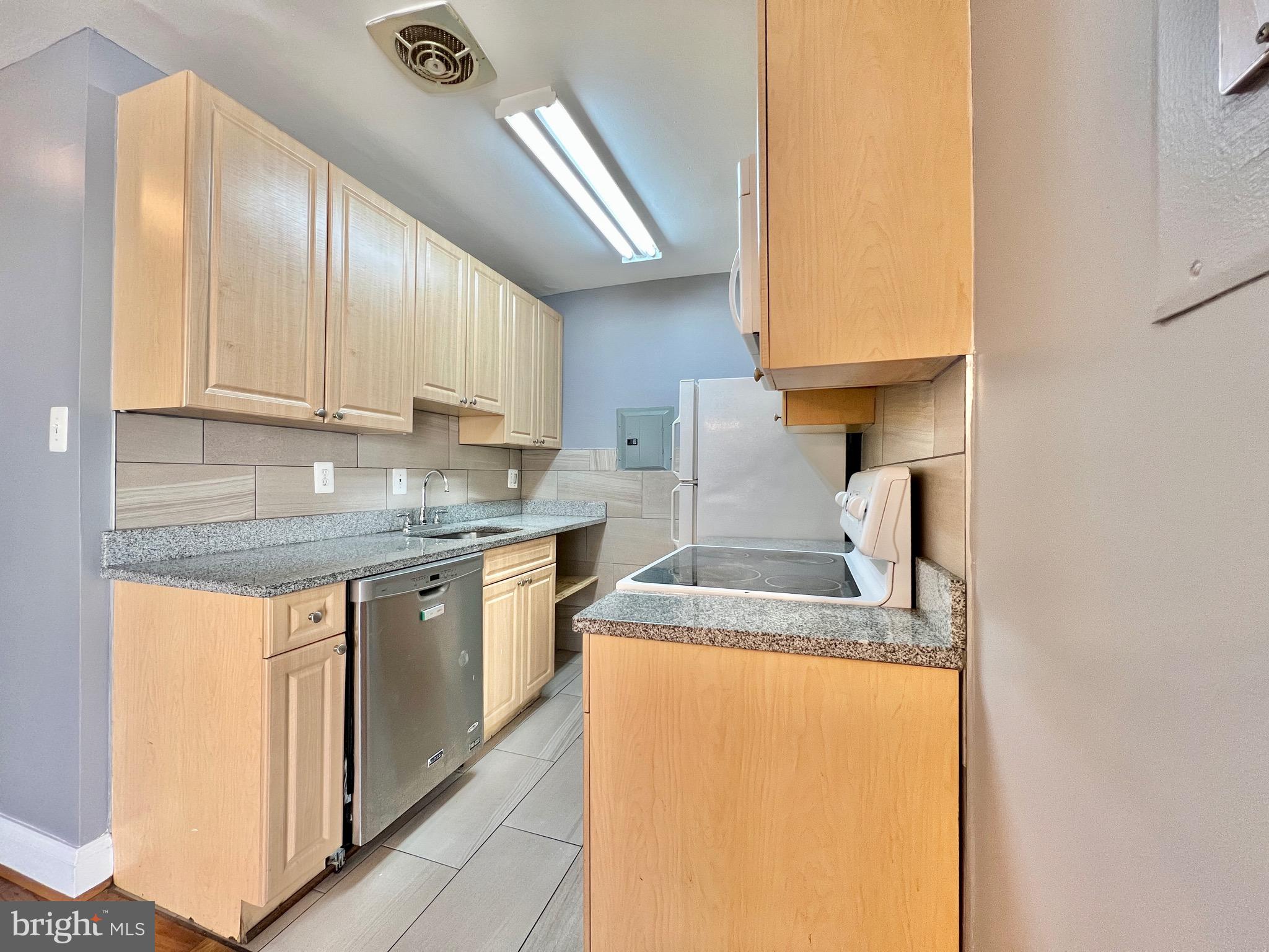 1009 Chillum Road, Unit 202 Hyattsville, MD 20782 - Photo 8 of 19 a kitchen with stainless steel appliances granite countertop a sink stove and cabinets