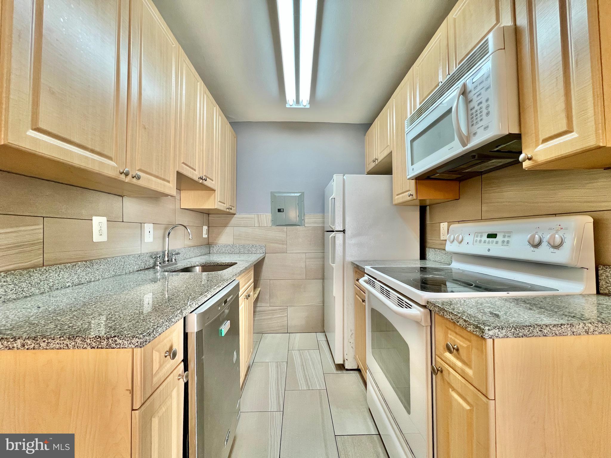 1009 Chillum Road, Unit 202 Hyattsville, MD 20782 - Photo 10 of 19 a kitchen with stainless steel appliances granite countertop a sink stove and cabinets