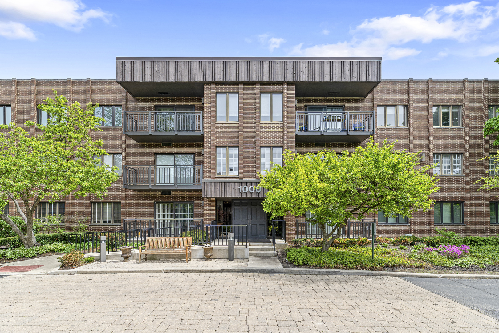 1000 Deerfield Road, Unit 101 Highland Park, IL 60035 - Photo 1 of 19 a front view of a house with garden