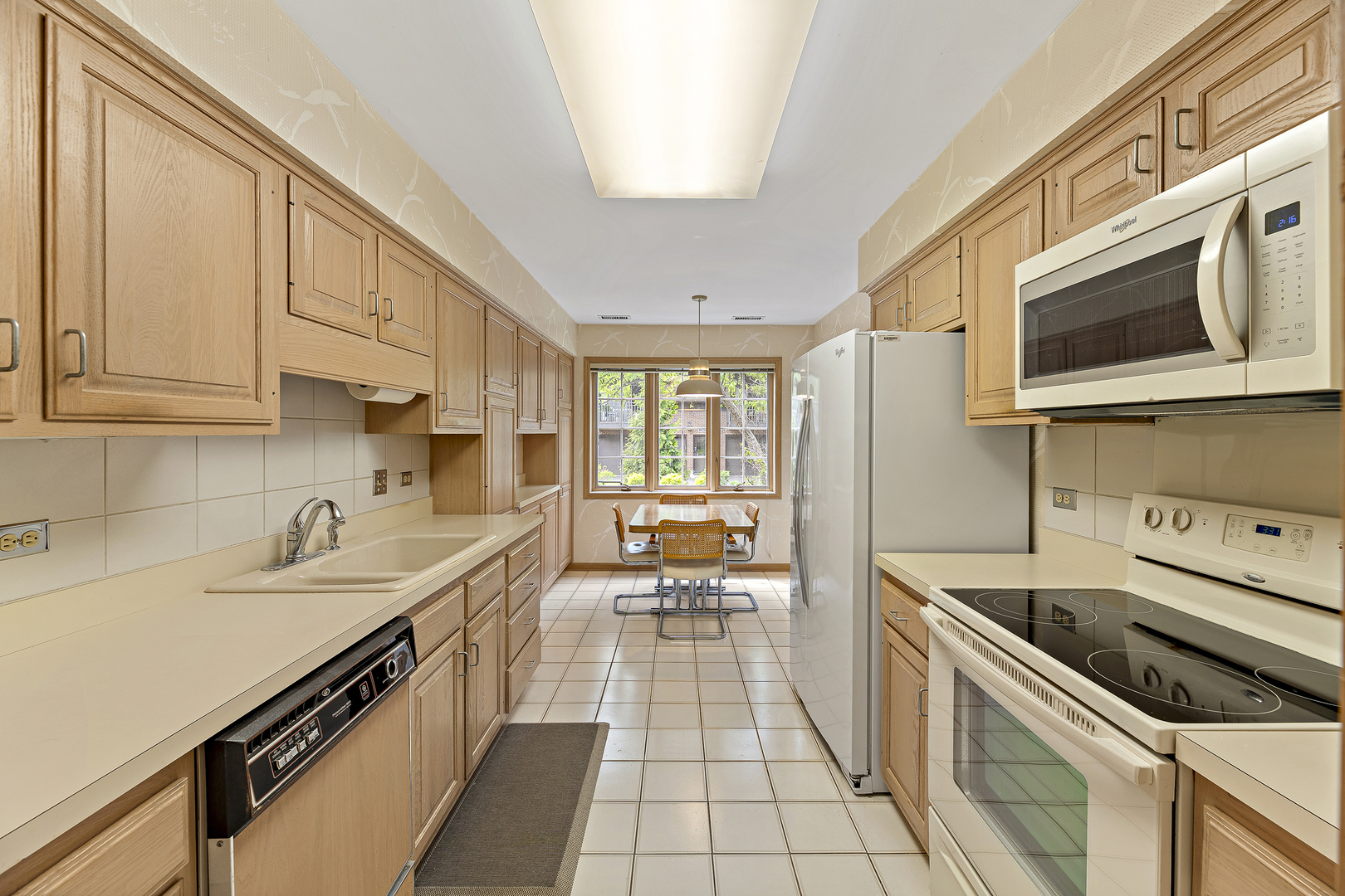 1000 Deerfield Road, Unit 101 Highland Park, IL 60035 - Photo 9 of 19 a kitchen with stainless steel appliances a sink stove and cabinets