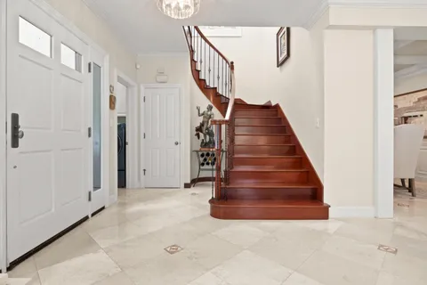 a view of a hallway with closet and wooden floor