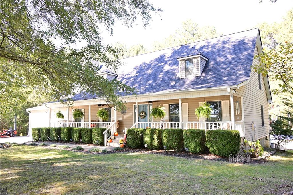 4575 Roland Hayes Parkway Southwest Calhoun, GA 30701 - Photo 1 of 1 a front view of a house with a yard and potted plants