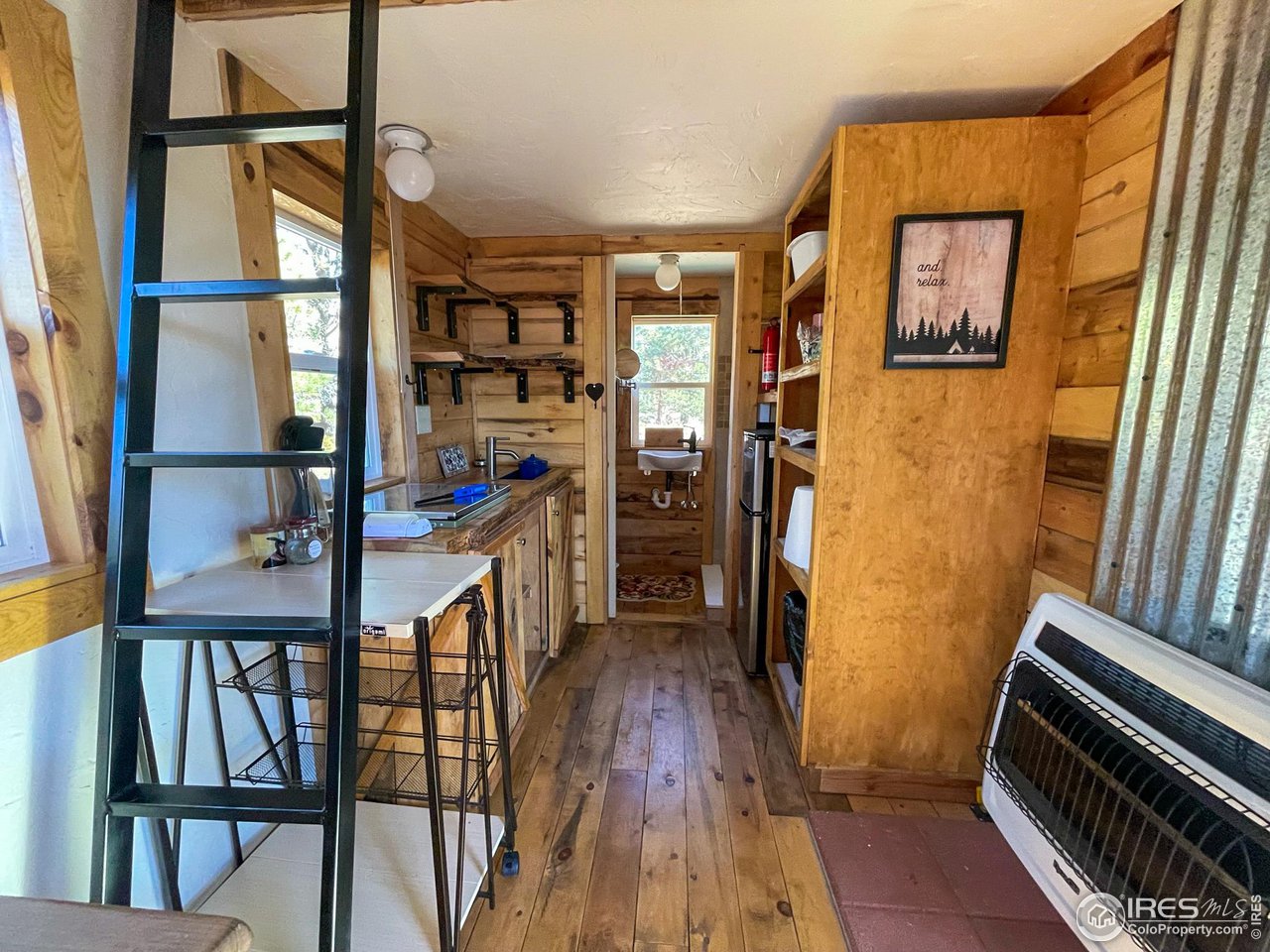 1448 Le Cook Road Allenspark, CO 80510 - Photo 31 of 39 a view of hallway with wooden floor and stairs