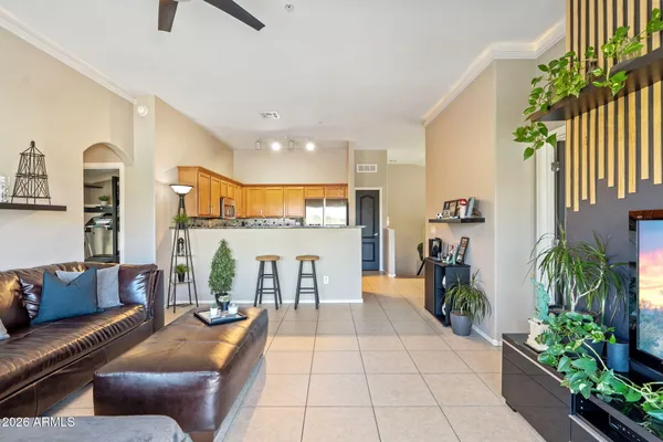 a living room with furniture a couch and potted plants