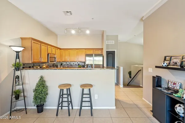 a living room with furniture a flat screen tv and a floor to ceiling window