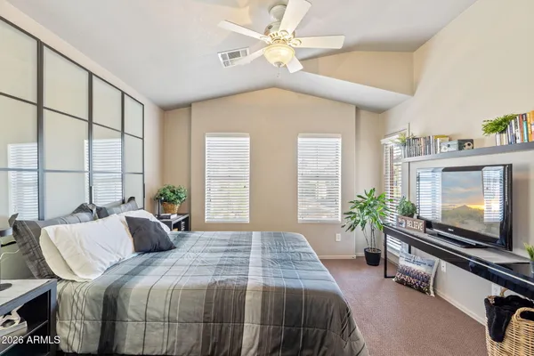 a bedroom with a bed and a flat screen tv